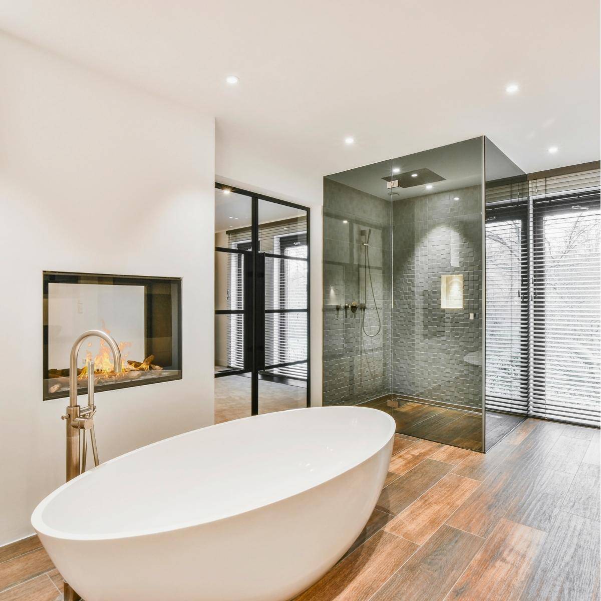Modern Bathroom with stand alone tub, built in fireplace and curdles shower