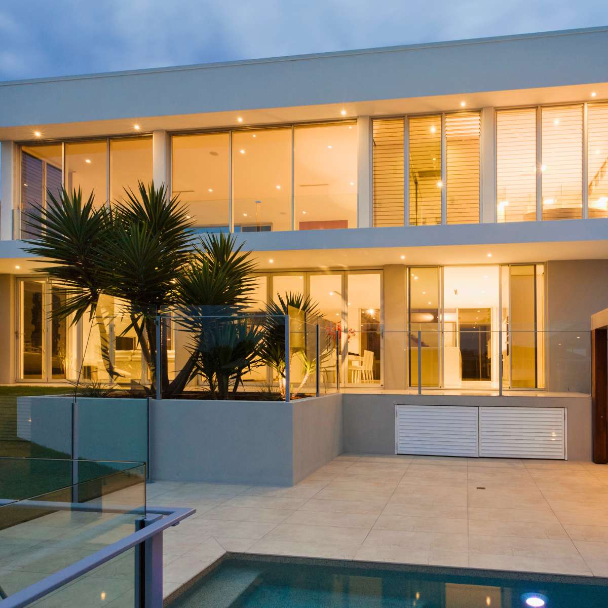 Modern Design of residential home, large modern windows, landscaped pool area and backyard