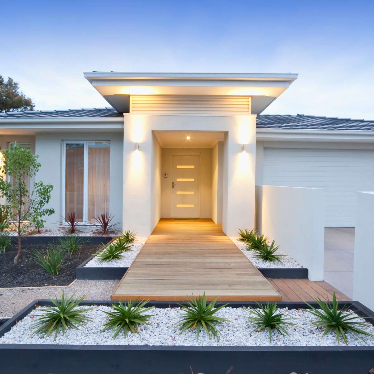 Modern Design of residential home, large modern entry door, landscaped front yard
