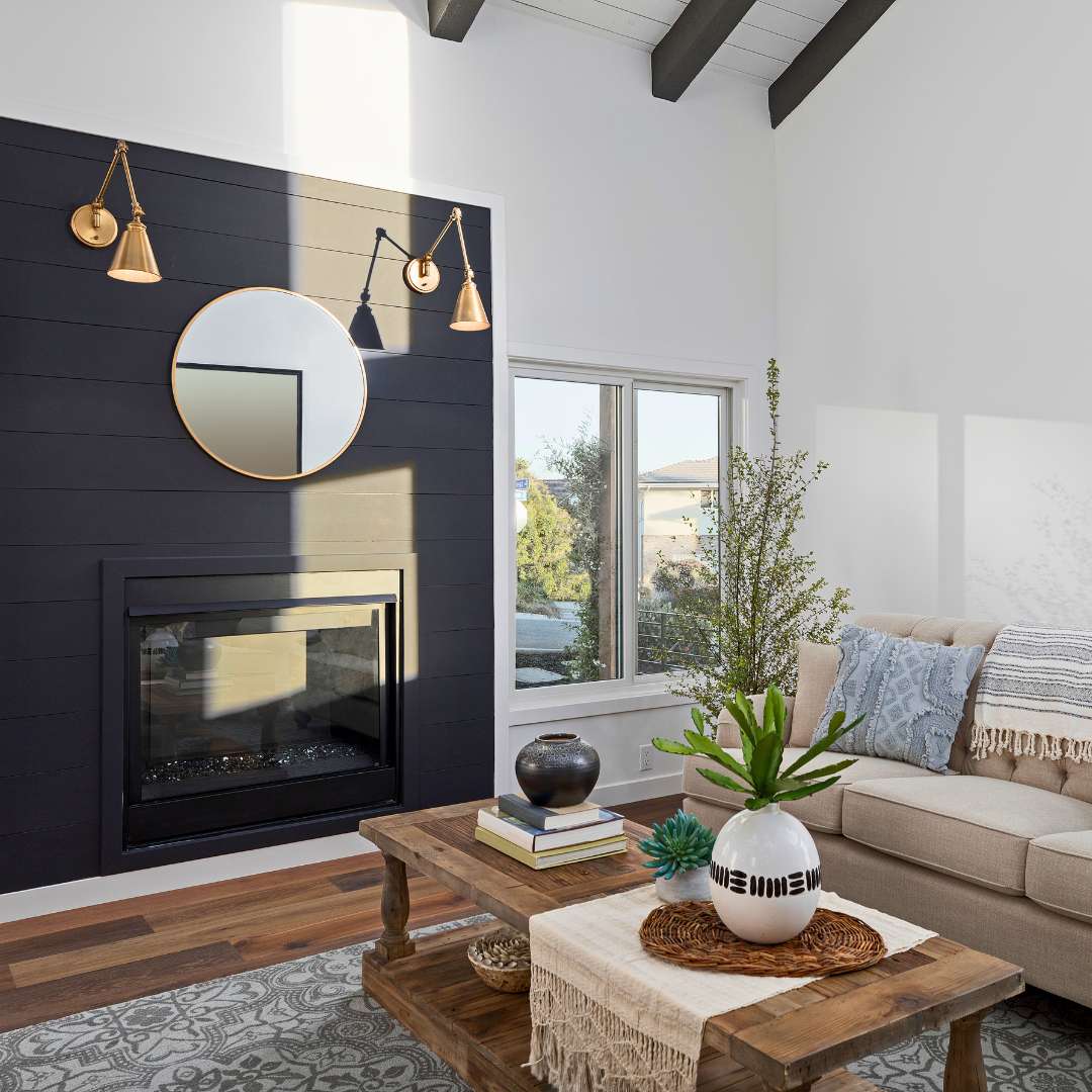 Residential Construction in Orange County, interior remodel with black wall cladding on fireplace in living room.