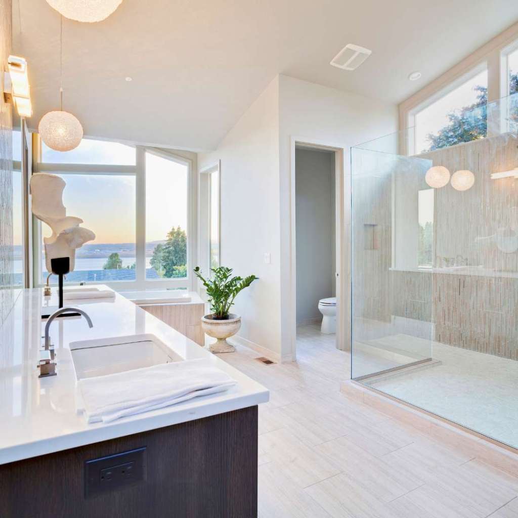 modern bathroom with white walls and countertops.