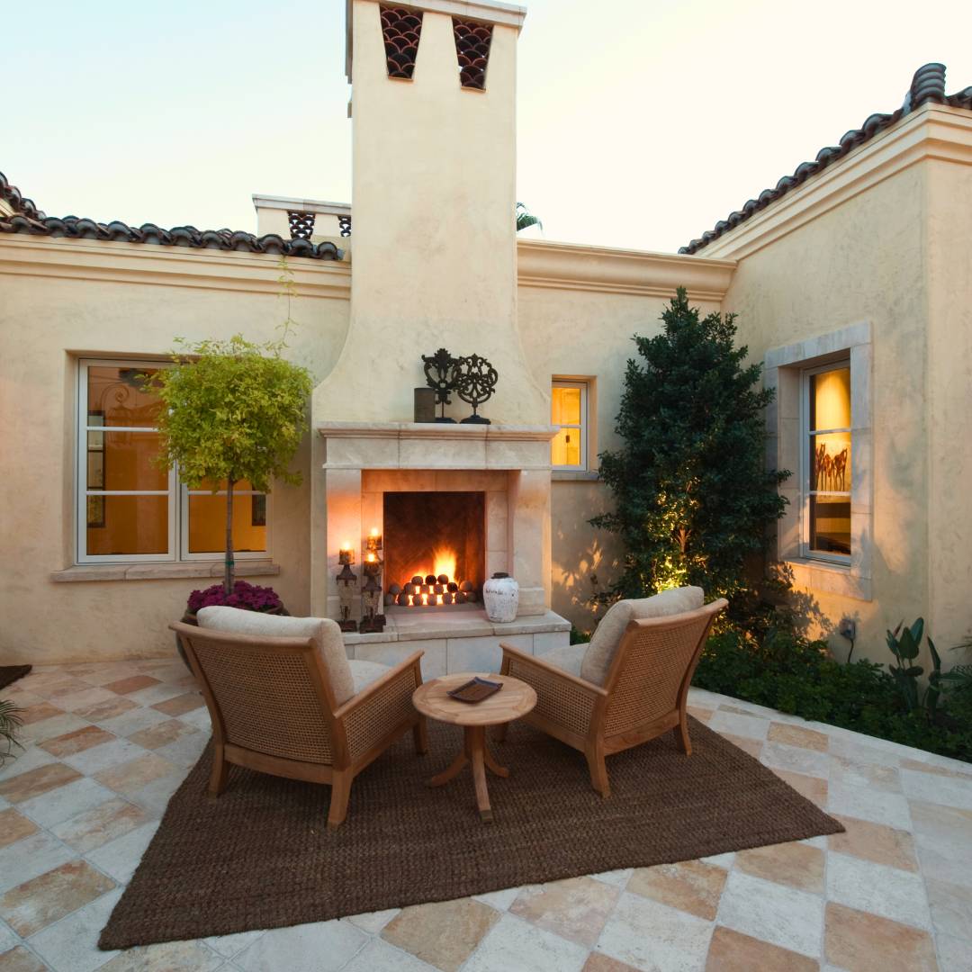 backyard remodel in Orange County of fireplace with chimney, smooth stucco exterior walls and stone pavers